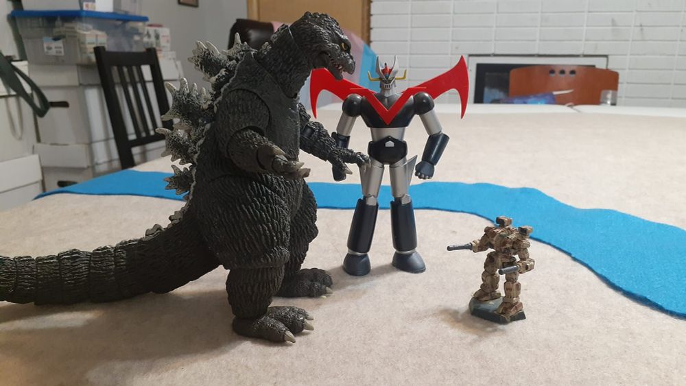 So you've got Godzilla, King of the Gosh-Darned Monsters, and Mazinger Z, (its invincible power is protecting us Justice in my heart, pilder on Flying high iron fist! Rocket Punch! It is now, got it now, Breast Fire! Magin go Mazin go Mazinger Z!), a giant super robut created by Go Nagai, standing over the diminutive form of a BattleTech Warhammer. 

They're really towering over it.

I mean... It's SO TINY in comparison, right? Like, these guys are totally going to be all "How's the weather down there?" because, let's face it, as much as I love Mazinger Z and Godzilla, they can kinda both be jerks about stuff.

Nobody's perfect.

But guys... Just lay off that tiny Warhammer okay?

Don't be rude. There's no need to be rude.

