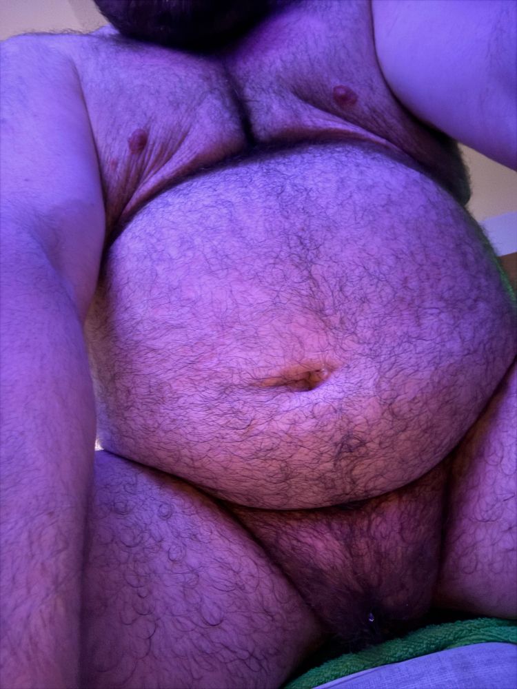 A fat, white, hairy belly on a masculine person right after they showered 