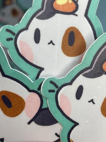 little calico bunny stickers with an orange on their heads