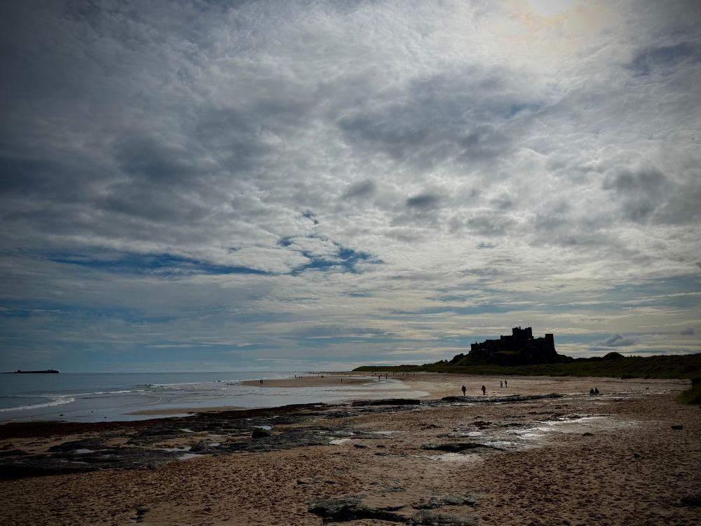 landscape image of Bamburgh Castle and beach.