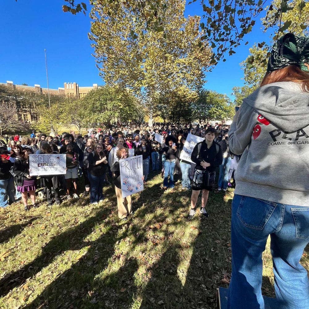 Students holding protest signs outside of Little Rock Central High