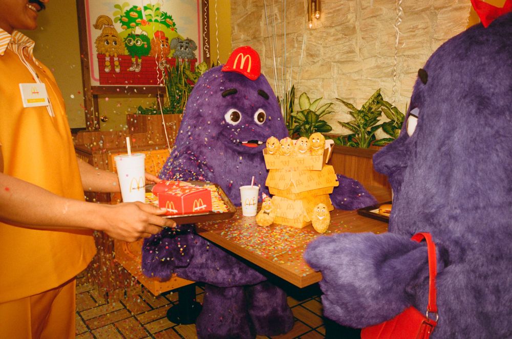 baby grimace celebrating his birthday at a table at mcdonald's