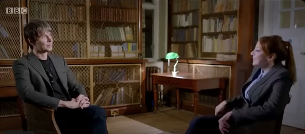 Prof. Brian Cox being interviewed by Philomena Cunk.