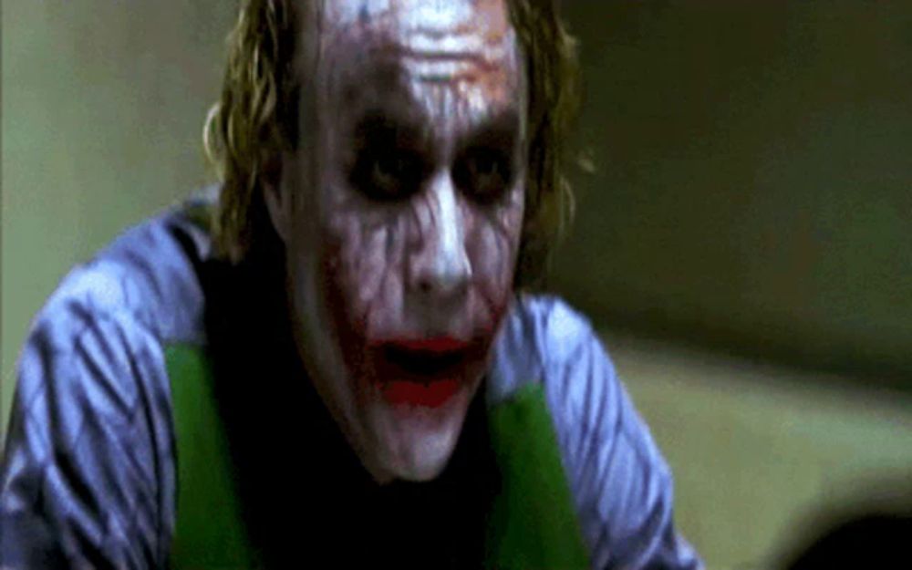 a close up of the joker making a funny face with his mouth open