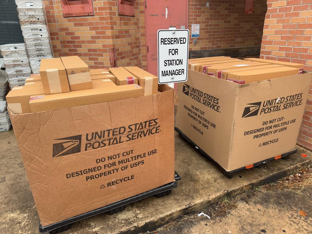 Photograph of two pallet boxes filled with cardboard boxes