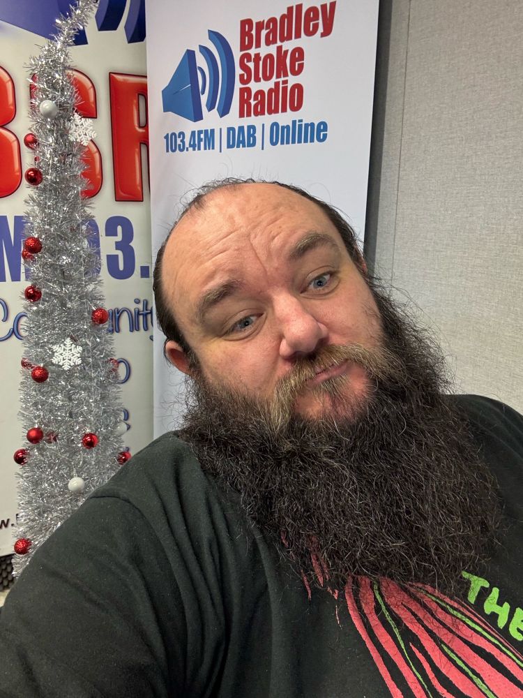 James in a black tee with Tribe’s Low End Theory cover on it. He has a silver Christmas tree behind and Bradley Stoke Radio branding. 