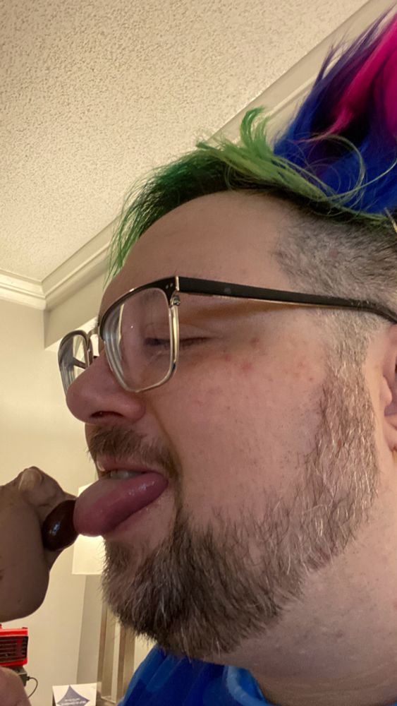 Licking a paw shaped ice cream treat.