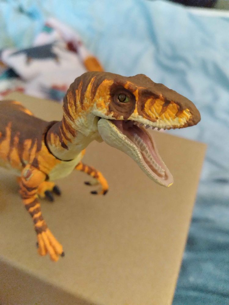 closeup shot of a repainted tiger raptor hammond collection