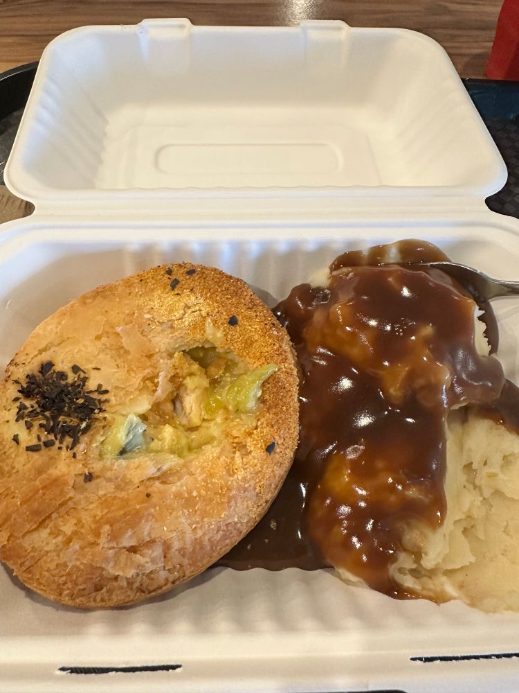 Picture of a pie & sides in a cardboard takeaway container. Chicken, leek, roast veg & tarragon pie with a polenta crust (delicious) + a side of creamy mashed potato & gravy. Perfect after a bit of a hike on a cold wet day 🥧 