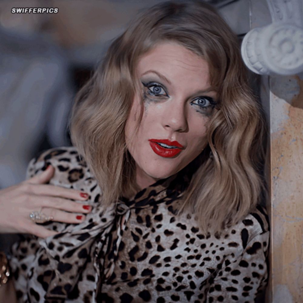 a woman wearing a leopard print shirt has a tear running down her face