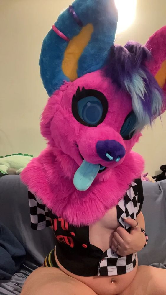 same person/outfit as before, but the top of my shirt is unbuttoned and I'm pulling it to the side in a teasing manner. my head is tilted in a playful and curious way. 