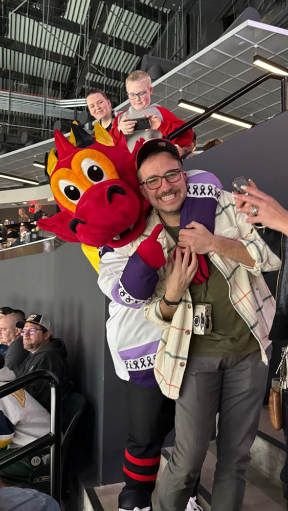 Friend being hugged by the Indy Fuel hockey team mascot