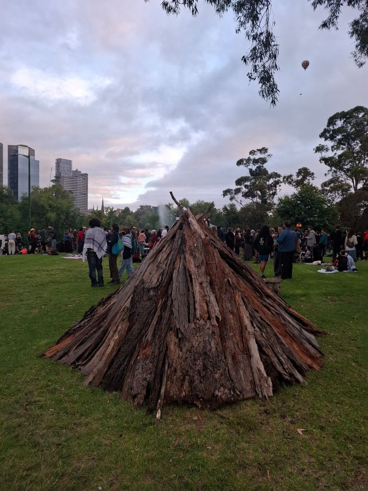 A bark tent and the city of Melbourne behind it