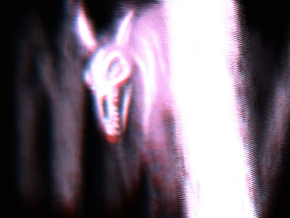 Spooky looking cryptid peering through the trees at the viewer