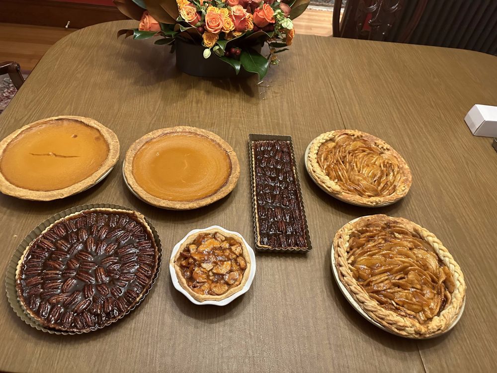 Seven pies: two pumpkin, two pecan, and three apple