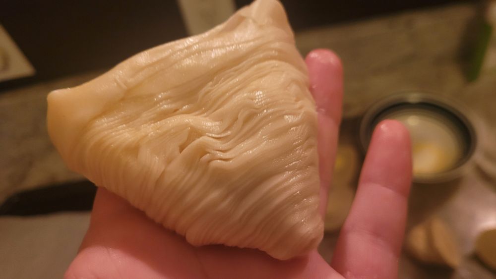 a slice of the log from the other image that has been pushed out like a cone, separating the pastry "rings"