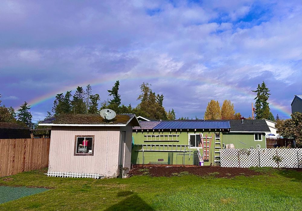 An entire rainbow, west to east, across the northern sky, above my shed and my neighbor’s outbuilding.