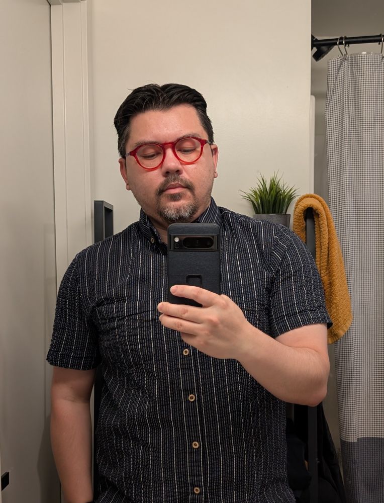 Me with red glassess wearing a blue seersucker stripped shirt