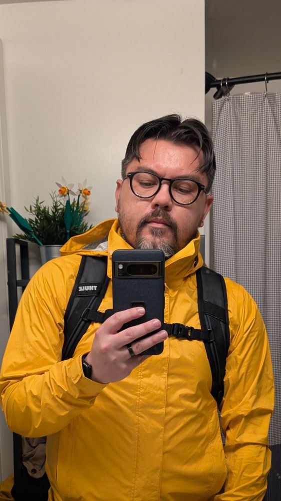 Bathroom mirror selfie of me in the bright ass yellow raincoat referenced in the post