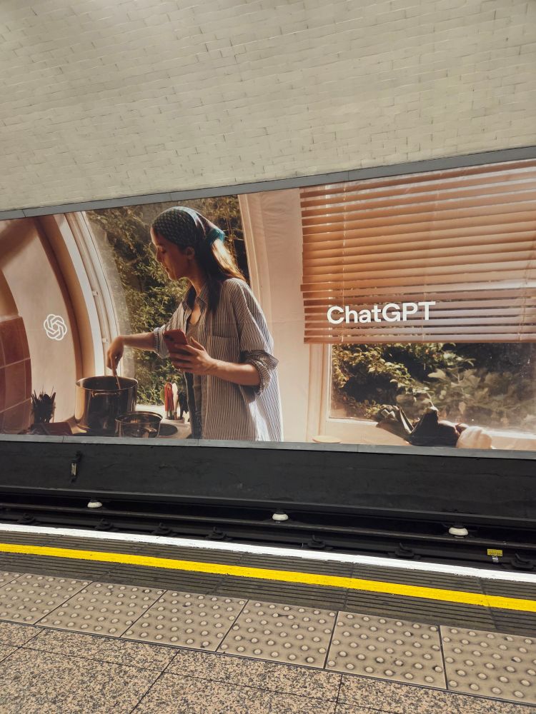 Ad for chat GPT featuring a woman cooking who is distracted by her phone.