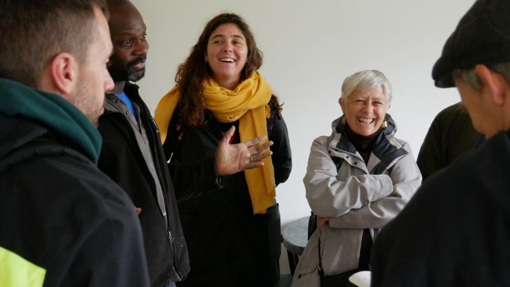 A householder shows visitors around his retrofit home. 