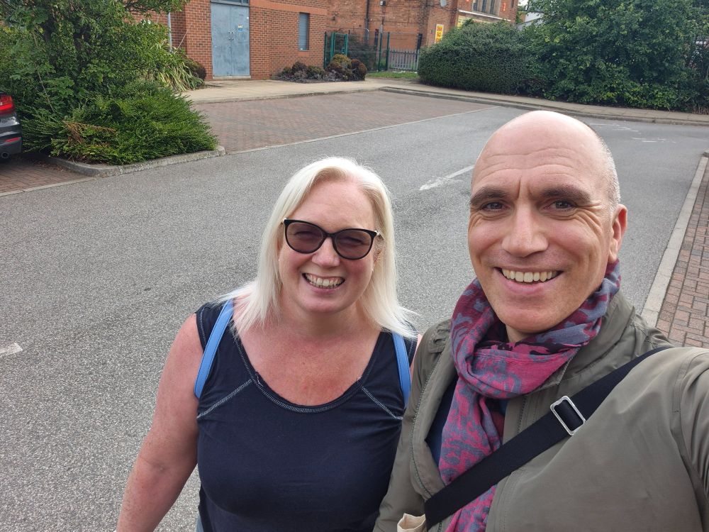 A woman and a man stood next to each other smiling.
