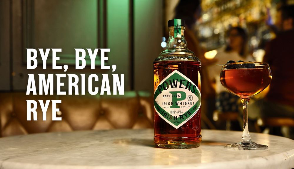 Image from https://www.powerswhiskey.com/en-us

Bottle of Powers Irish Rye in clear glass bottle, diamond label in white with green border "Powers Irish Whiskey Irish Rye" in three lines in black text against a capital P in green. 

Captioned "Bye, Bye, American Rye" 