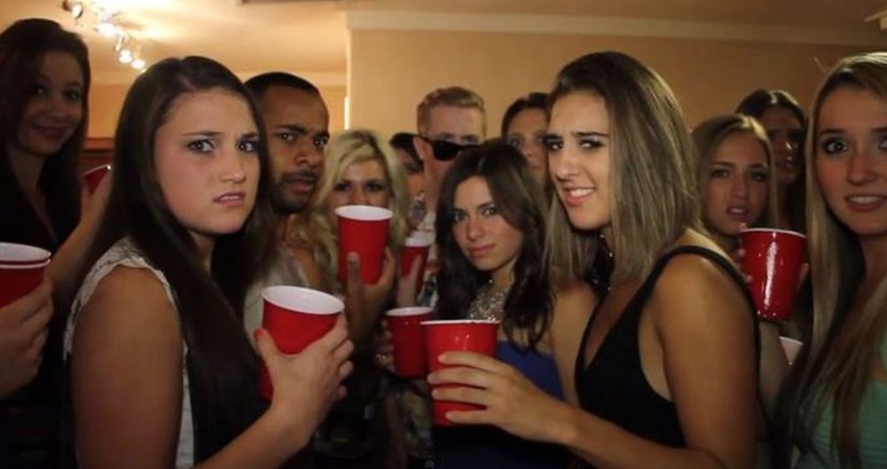 Meme reaction photo of a group at a party looking back at the camera in disgust 