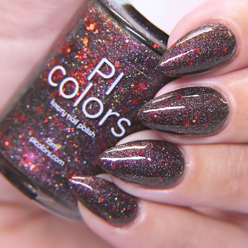 black nail polish with red and silver holo glitter and mild red to gold shimmer