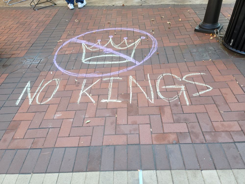 Chalk drawing of the "No Kings" emblem with NO KINGS written below it. 