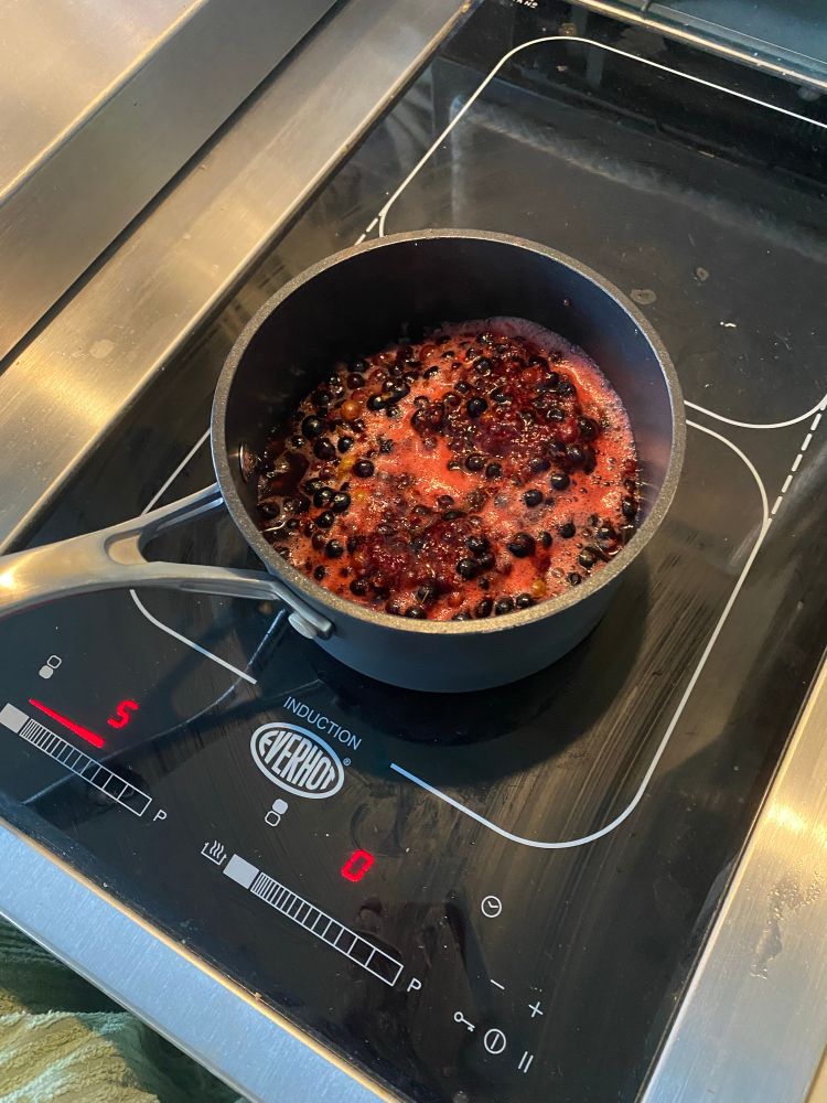 Simmering the blackcurrants in making a sauce