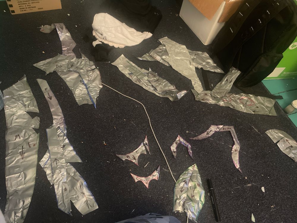 Duct tape dummy pattern cut out and organized on the floor