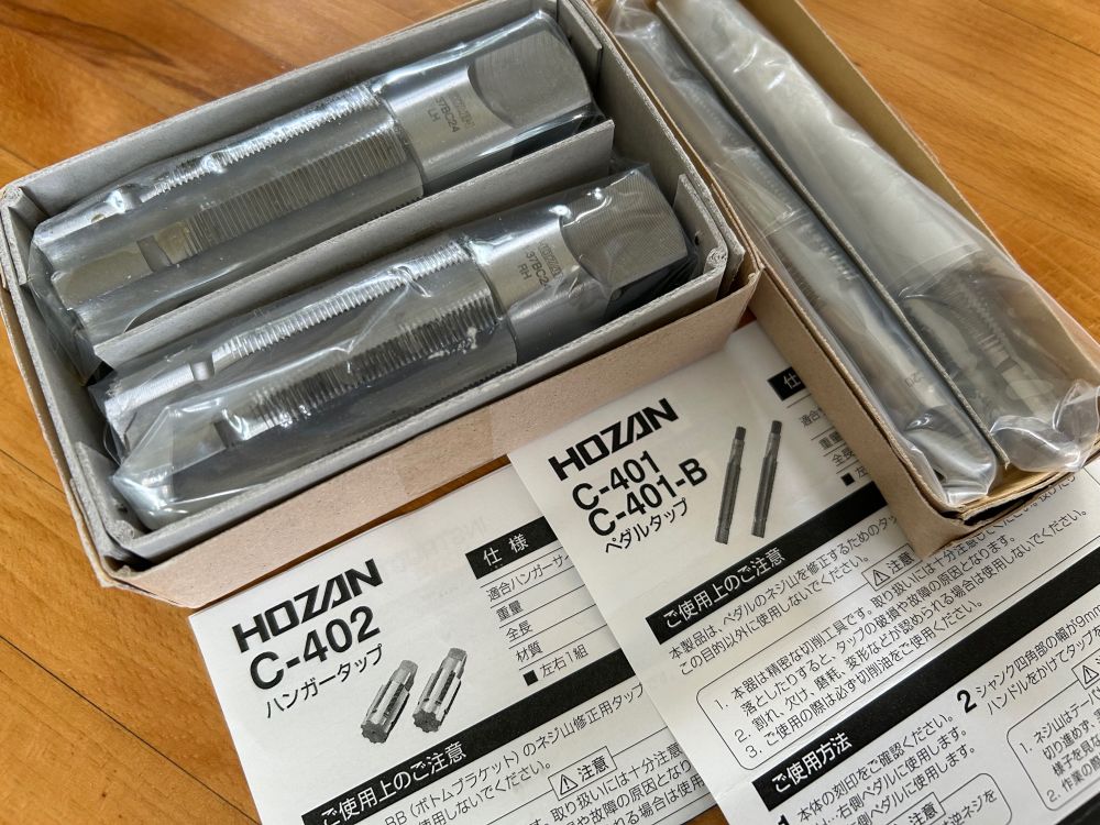 photo shows steel taps wrapped in plastic on a wood table withprinted instructions