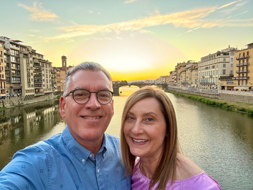 Doug and his wife, on the Ponte Vecchio Bridge at sunset.