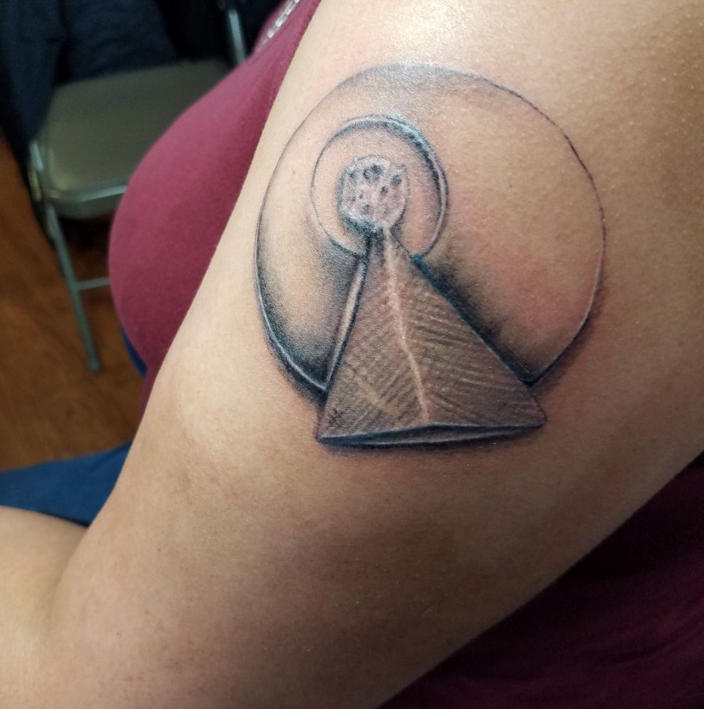 Tattoo on brown skin of the IDIC (Infinite Diversity in Infinite Combinations) from Star Trek.