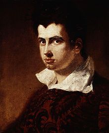 James Henry Leigh Hunt, by Benjamin Robert Haydon (died 1846).

Hunt is depicted as a young man with dark, wavy hair, intense eyes, and a strong gaze that conveys intellectual depth and determination. His facial features are sharply defined, with high cheekbones and a prominent nose, emphasizing his expressive and thoughtful demeanor.

He wears a rich, deep red garment with intricate patterns, and his white collar is open and slightly upturned, adding a sense of romanticism and individuality. The background is dark and muted, focusing attention on Hunt’s face and expression.