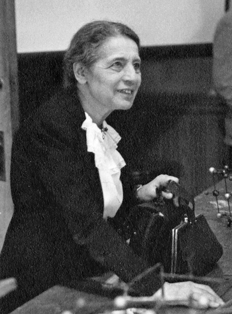 Lise Meitner (1946)

Smithsonian Institution - Flickr: Lise Meitner (1878-1968), lecturing at Catholic University, Washington, D.C., 1946.

Lise Meitner is seen in the midst of delivering a lecture. Her posture appears engaged and deliberate—she may be gesturing, holding notes, or pointing toward unseen lecture materials. She is dressed in period-appropriate attire, likely a blouse and dark jacket, conveying a professional and composed appearance.

In 1938, Austrian-born physicist Lise Meitner (1878-1968) fled Germany and eventually became a Swedish citizen. After World War II, Meitner received many awards, including being named "Woman of the Year" at the National Press Club in 1946. She was a Visiting Professor of Physics at Catholic University during Spring 1946. In a press release associated with her arrival, Dr. Meitner emphasized that her goal was "wholly educational": "I have no intention to suggest how atomic energy should be controlled, beyond expressing my sincere hope that no occasion will again arise where it will be utilized in war. A lasting peace is more desirable than the creation of weapons which might lead to the extermination of mankind."

https://de.wikipedia.org/wiki/Lise_Meitner#/media/Datei:Lise_Meitner_(1878-1968),_lecturing_at_Catholic_University,_Washington,_D.C.,_1946.jpg