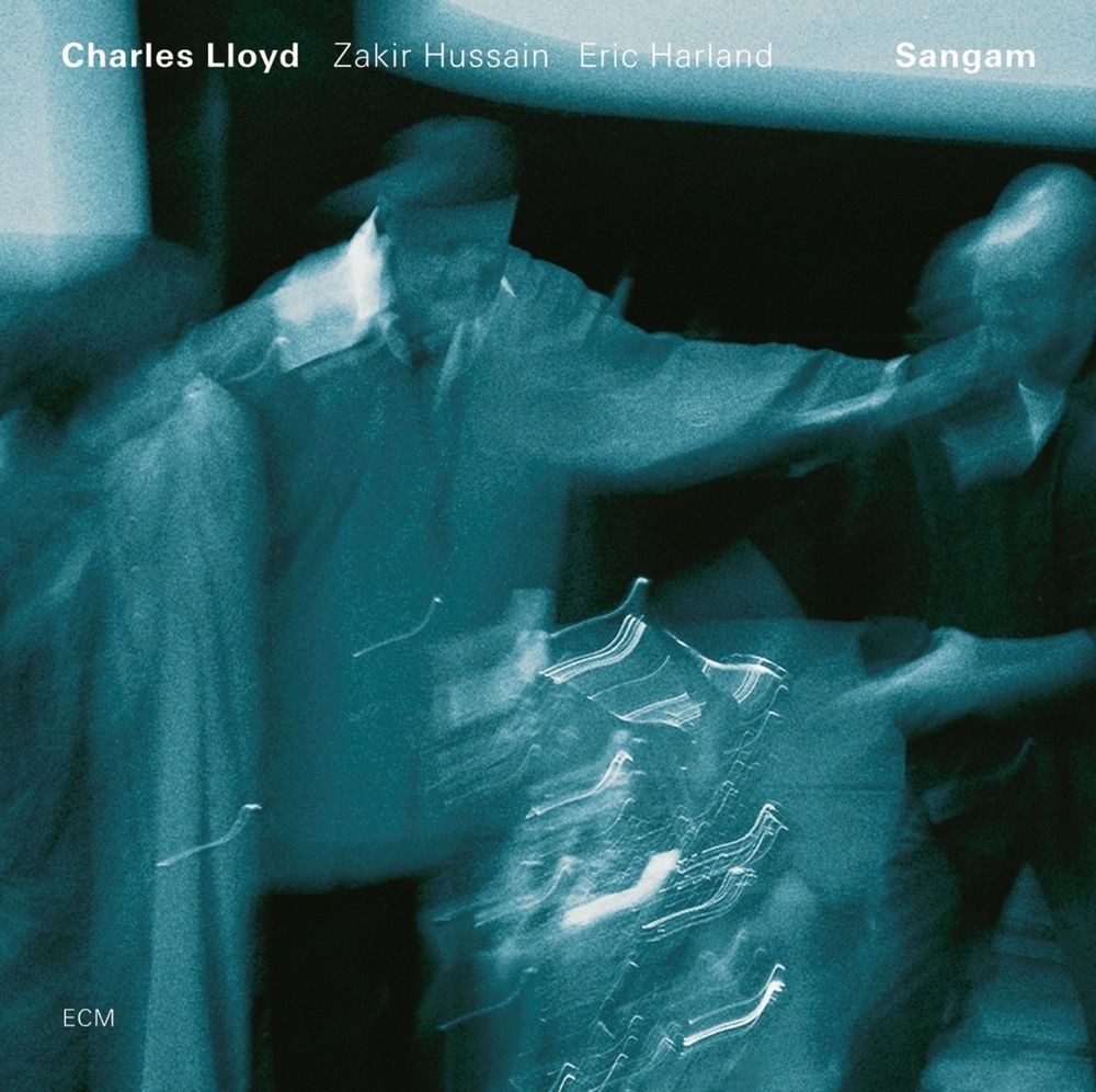 Cover art for the album Sangam, with Charles Lloyd, Zakir Hussein, and Eric Harland. Blurry, long-exposure photograph of three guys playing music. Blue toned