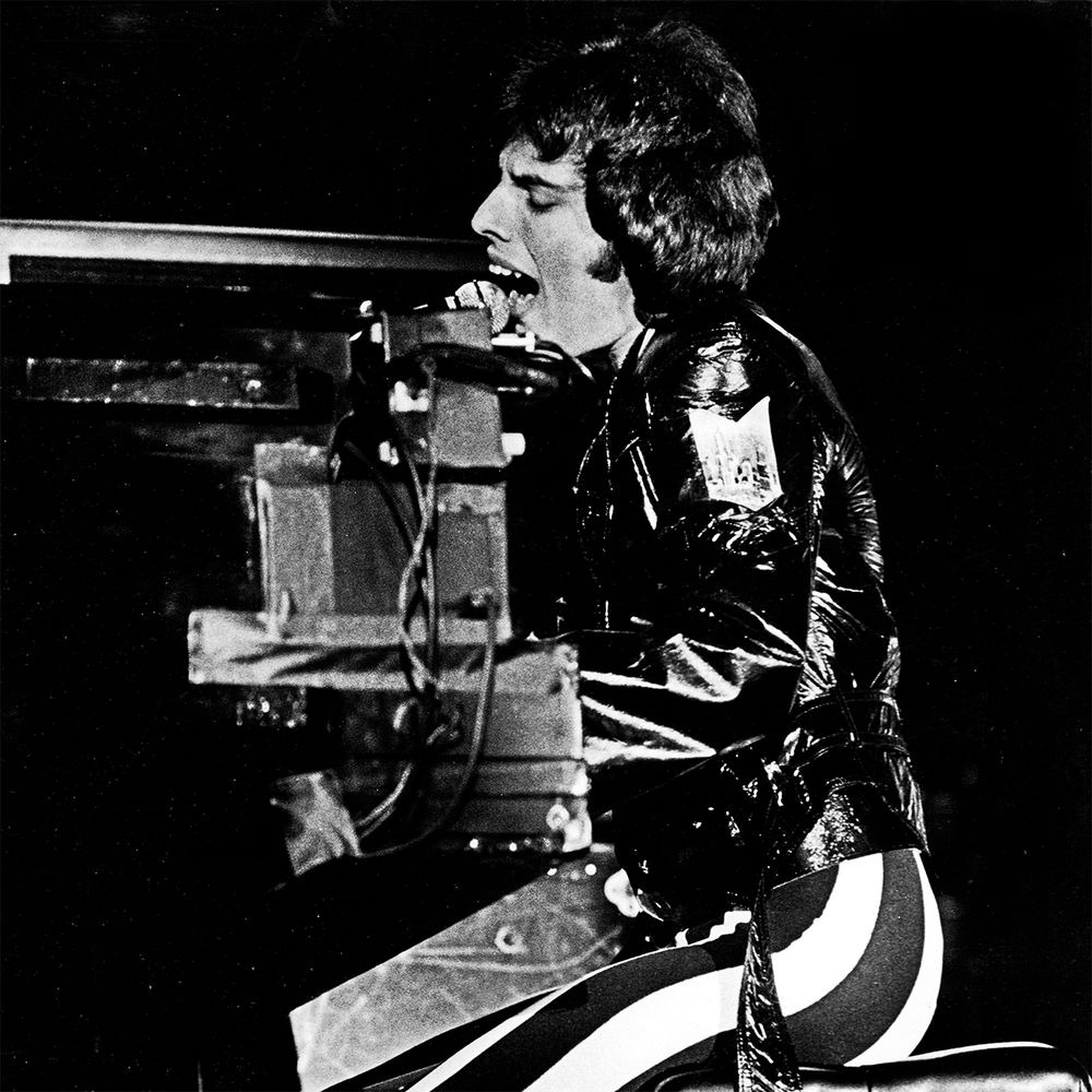 Black and white photo of Freddie mercury playing piano
