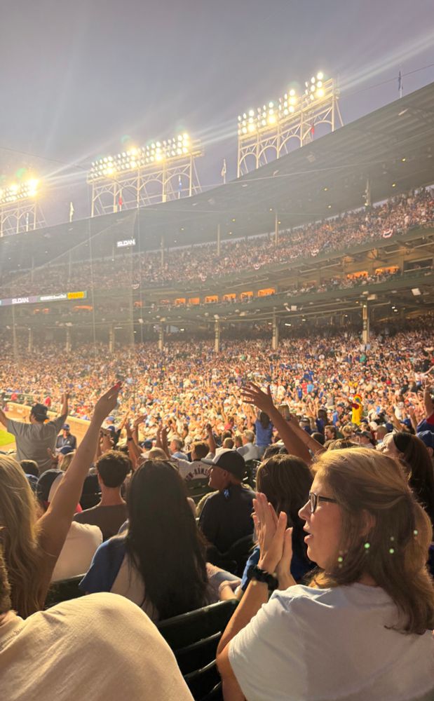 A group of fans do the YMCA dance at Wrigley Field