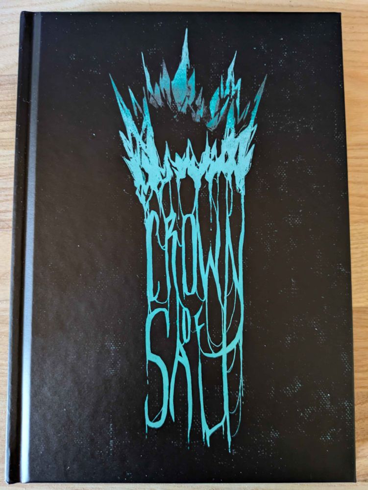 The Crown of salt cover with the title dripping from an ice blue crown on black background. 