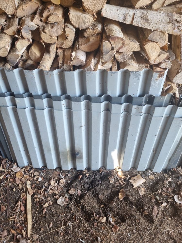 Pictures of signs of lightning damage to sheets of metal that was standing near the tractors back wheels. Behind the sheets? Dry fire wood. Close call...