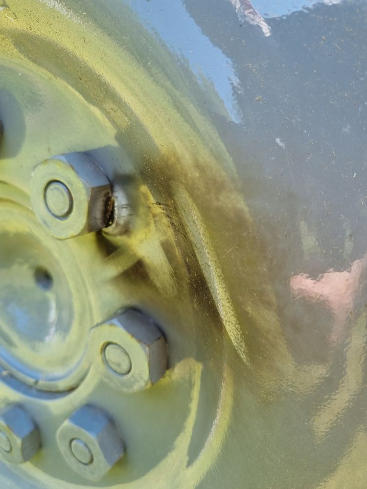It looks like lighting has struck the tractor. Both rear wheels have signs of electric arches formed from the wheel studs to the nut and from the edge of the rim to the ground. There are no signs of damage on the tractor garage that I have noticed.