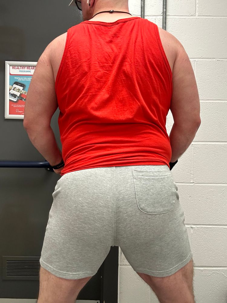 Bear is racing away from the camera with his ass in grey sweatshorts. There’s a tiny sweat line along my crack. 