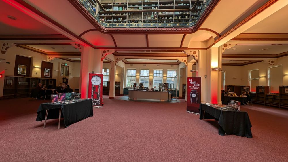 A gothic former library with red lighting. 