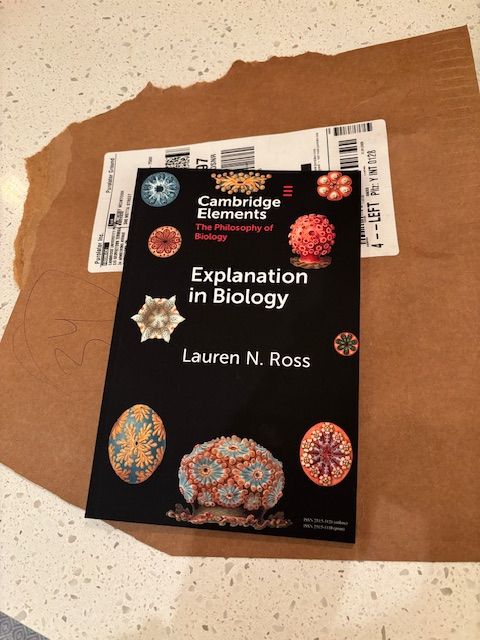 Book on a counter, titled Explanation in Biology by Lauren N Ross.