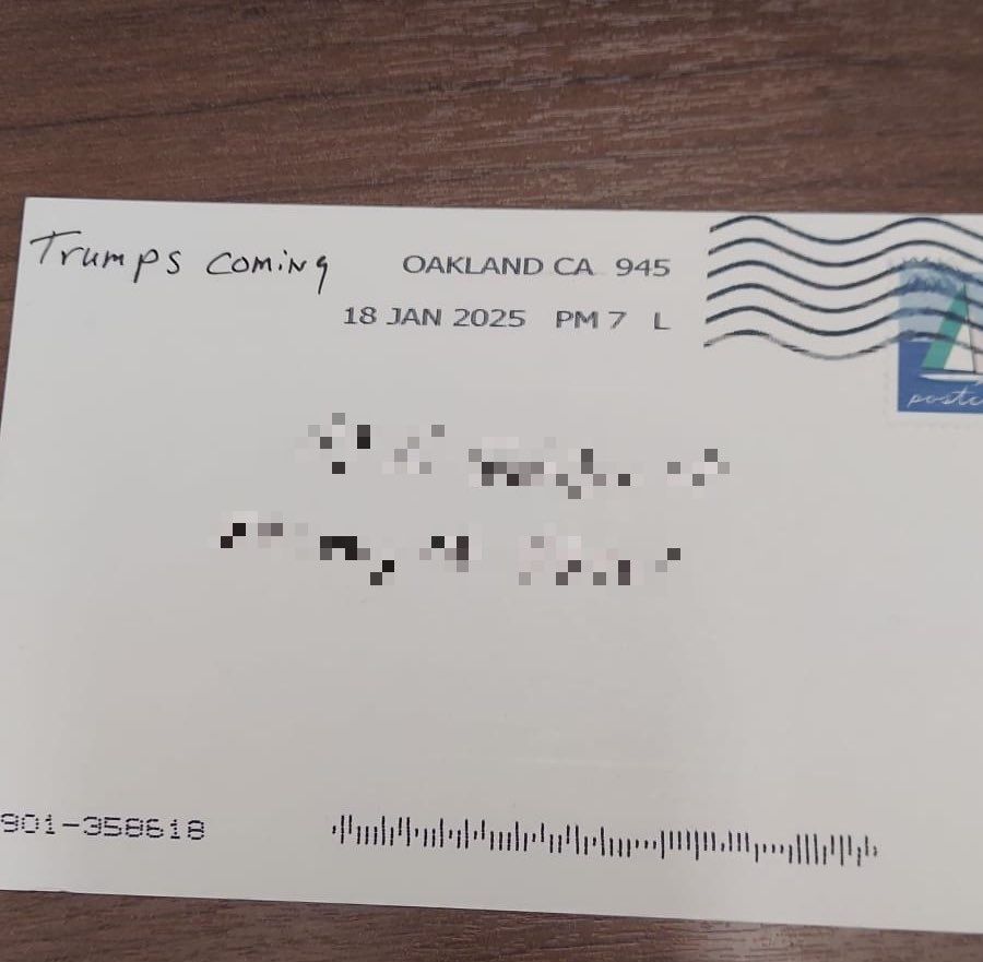 back of a postcard, address obscured by pixels, sent from Oakland, CA
sender name is "Trumps Coming"
