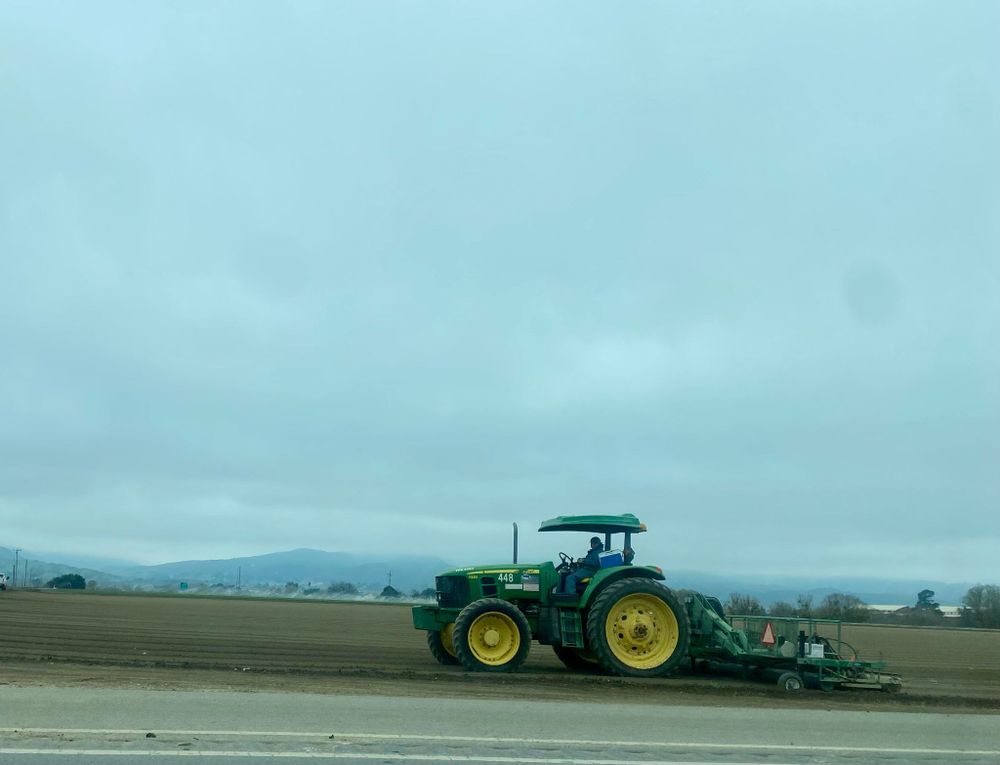 Farm worker on a tractor using the tractor and attachment to shape the “beds" for the new crop. 