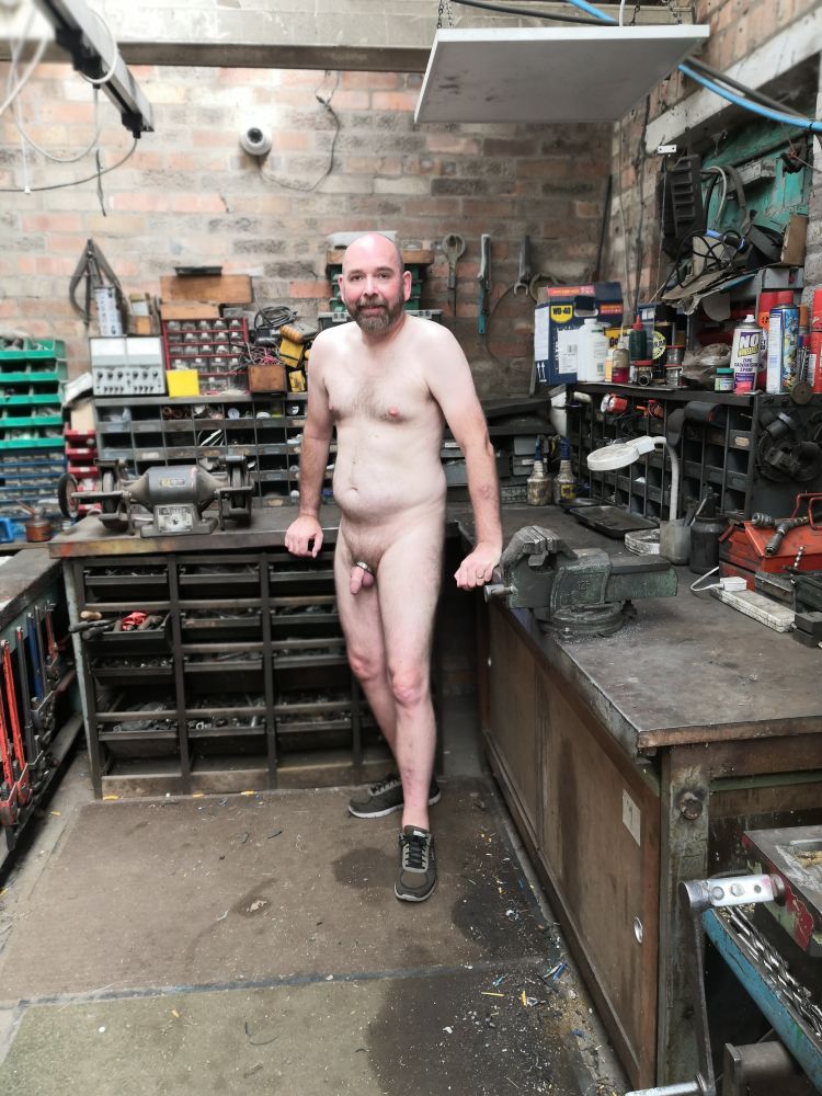 Naked man in workshop