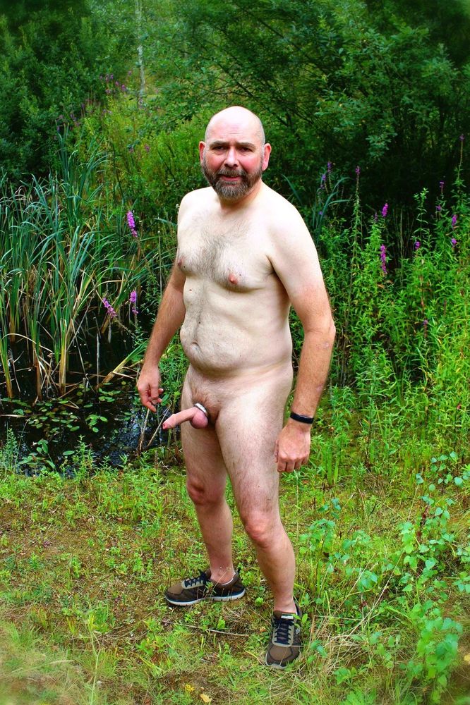 Naked guy outdoors. Semi erect